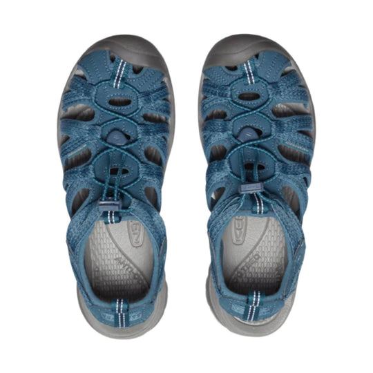 Blue closed-toe hiking sandals with bungee laces, side cutouts, and gray soles, shown from above