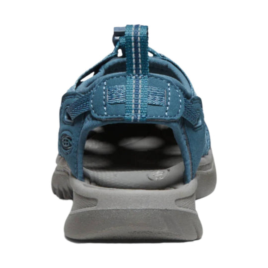 Blue-gray closed-heel sport sandal with a pull tab, padded heel strap, and thick gray sole, rear view