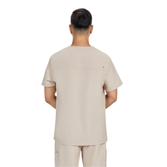 Back view of a light beige scrub top with short sleeves and matching pants