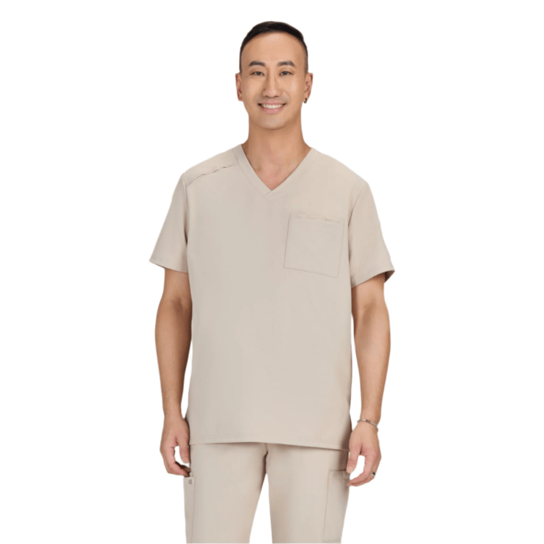 Beige V-neck scrub top with short sleeves and chest pocket, shown with matching scrub pants