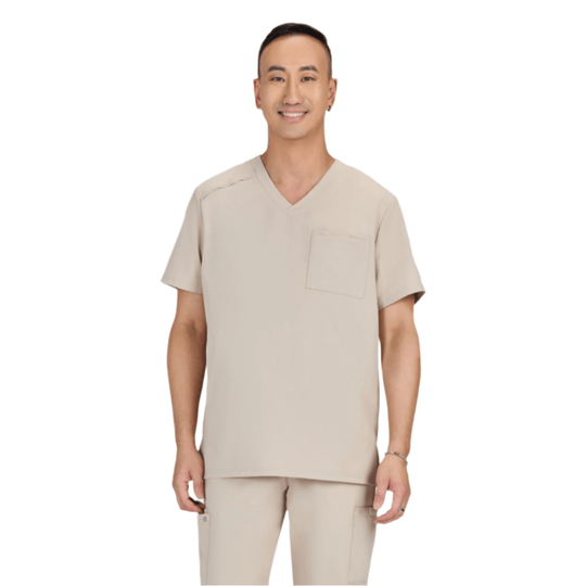 Beige V-neck scrub top with short sleeves and chest pocket, shown with matching scrub pants