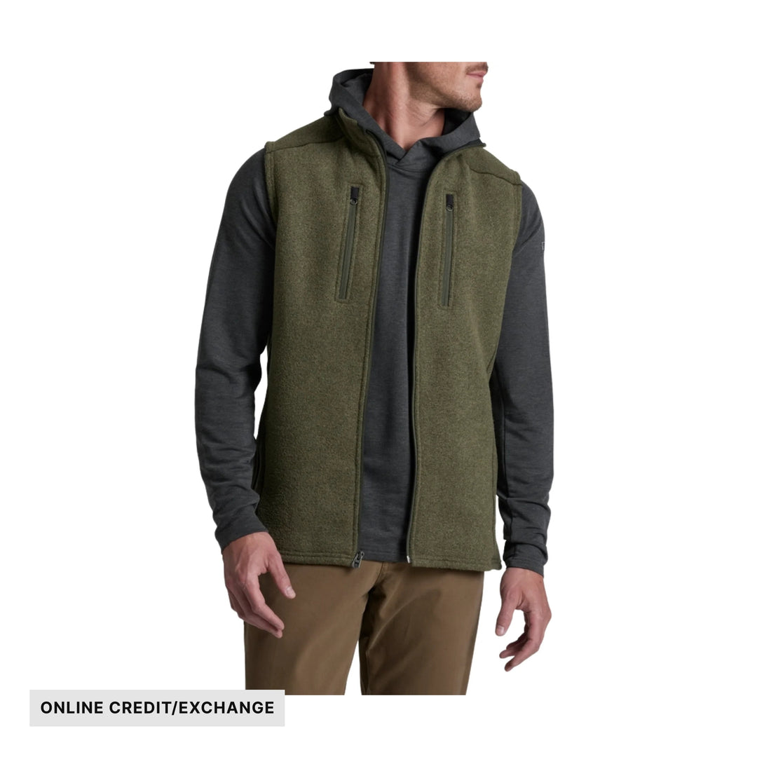 Olive fleece vest over a dark long-sleeve shirt, with front zippers and visible "ONLINE CREDIT/EXCHANGE" text