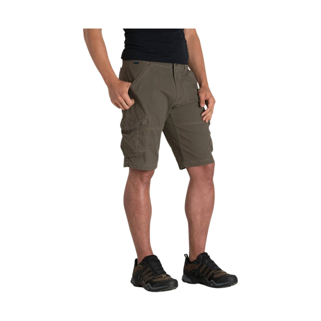 Olive cargo shorts with side pockets, shown on a model with a black shirt and hiking shoes