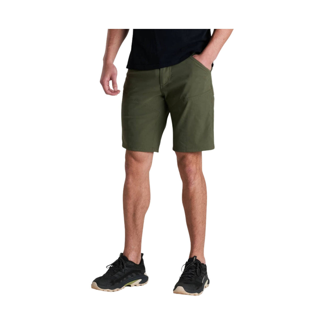 Olive green athletic shorts with side hand pockets, shown on a model