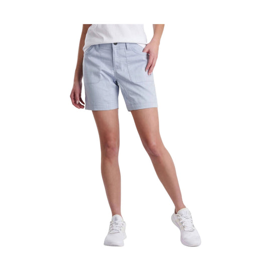 Light blue tailored shorts with front pockets, worn with a white shirt and white sneakers