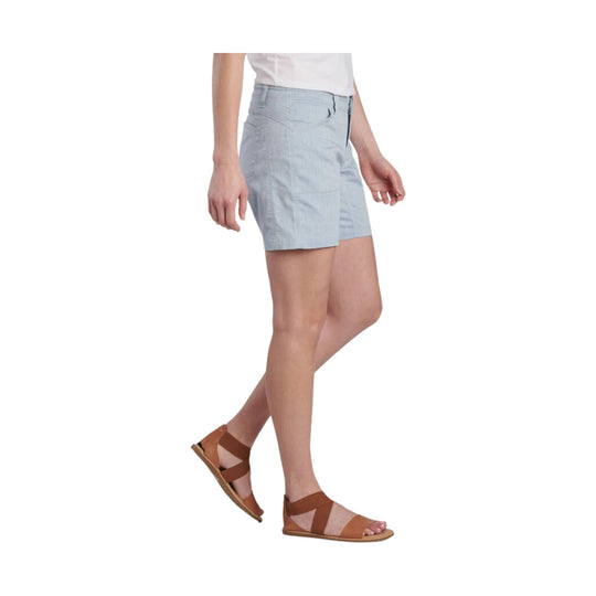 Light blue tailored shorts with front pockets, shown on a model from the side