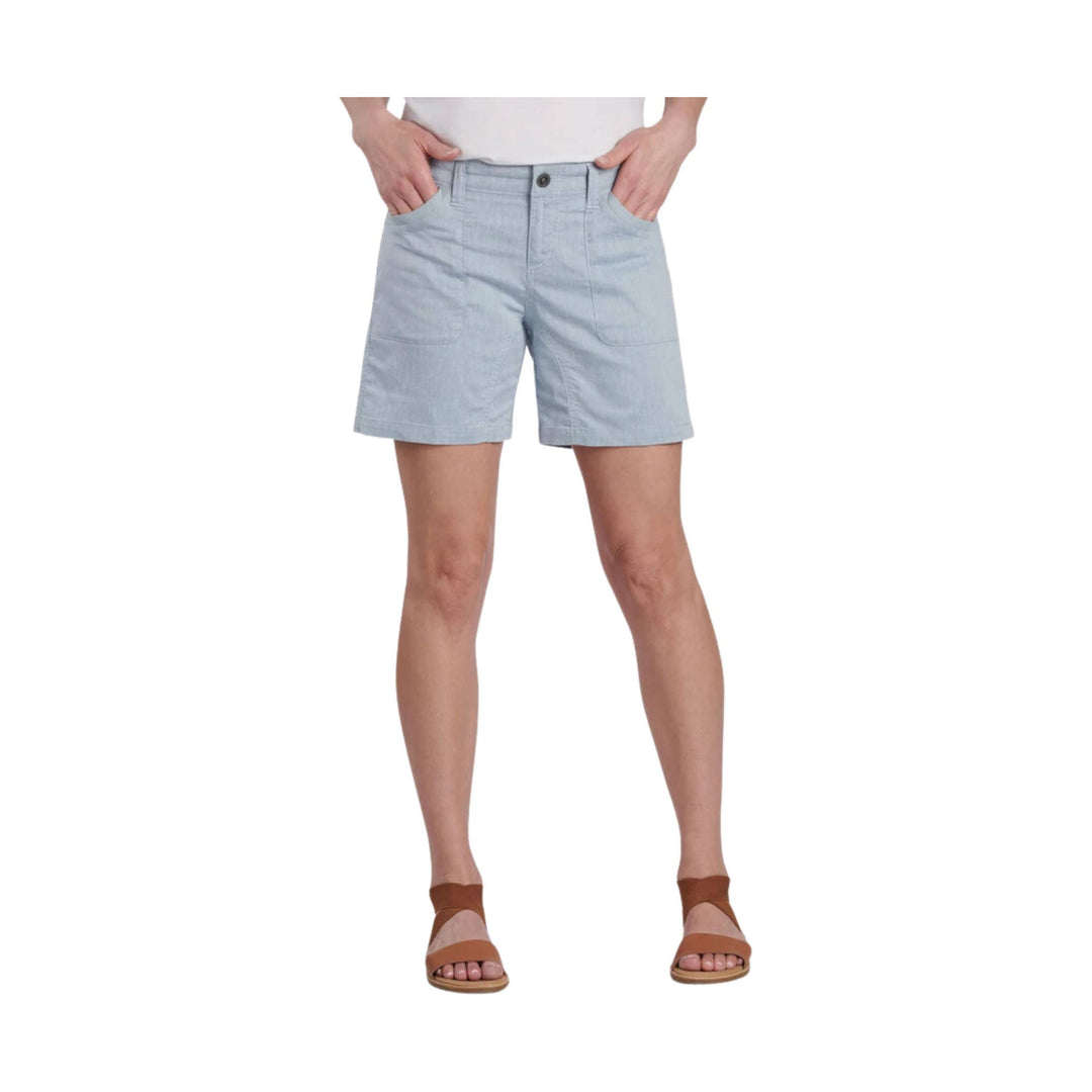 Light blue tailored shorts with front patch pockets and a button waist, shown on a model