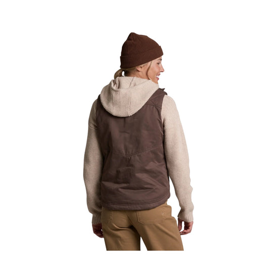 Brown lined vest worn over a cream hooded sweater, shown from the back
