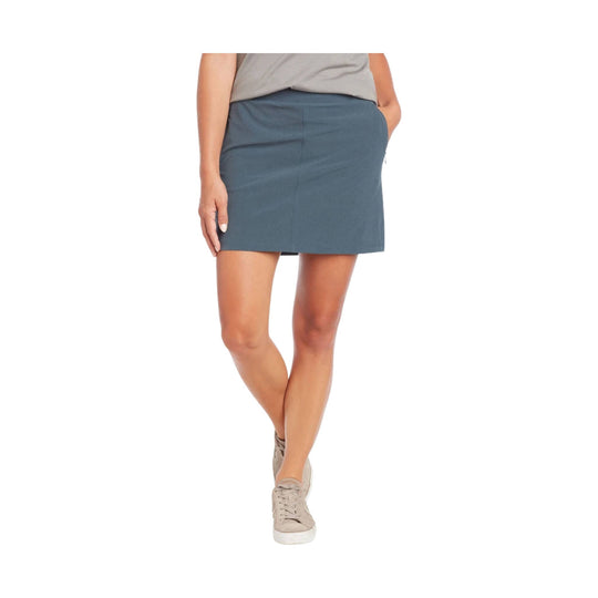Blue-gray skort with built-in shorts and beige sneakers, shown on a model from shoulders to feet