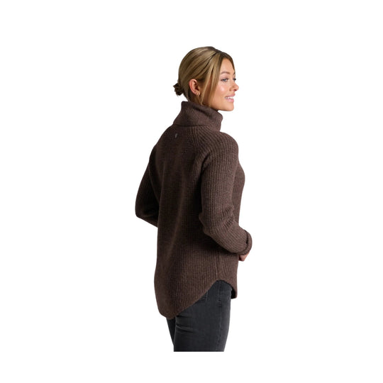 Brown ribbed turtleneck sweater shown from the back, paired with dark jeans