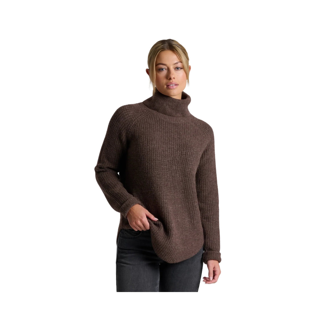 Woman wearing a brown ribbed turtleneck sweater with long sleeves and a curved hem