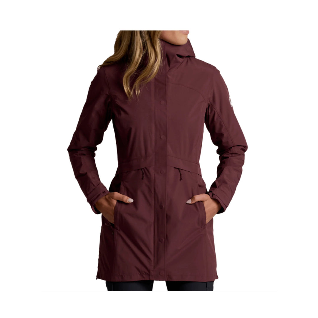 Burgundy hooded insulated coat with front snap closure, zip pockets, and hands in pockets