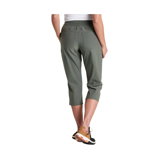 Olive pull-on capri pants shown from the back on a model, with cropped legs and side pockets