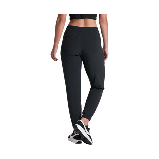 Black tapered jogger pants with zip back pockets and ankle cuffs, shown on a model