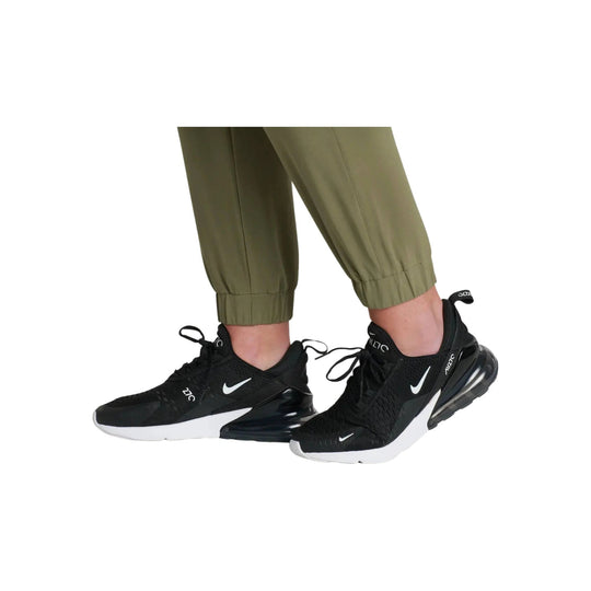 Black Nike-style athletic sneakers with white swoosh and air cushion heel, worn with olive jogger cuffs