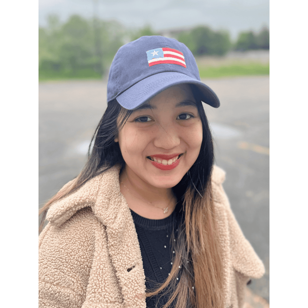 Dark blue baseball cap with a stitched red, white, and blue flag patch