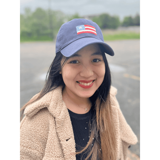 Dark blue baseball cap with a stitched red, white, and blue flag patch