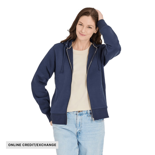 Navy zip-up hoodie over a beige T-shirt with light wash jeans