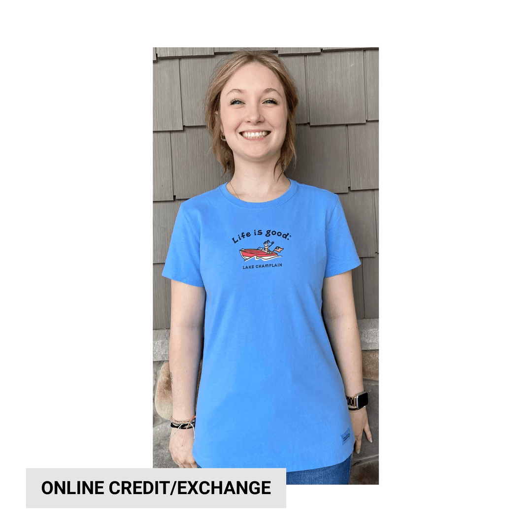 Blue short-sleeve T-shirt with a small chest graphic and a smiling model wearing it