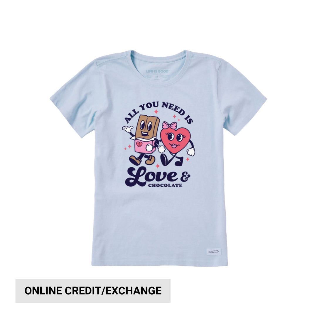 Light blue graphic T-shirt with two cartoon characters and the text “All You Need Is Love & Chocolate.”