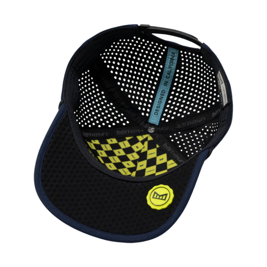 Black baseball cap with perforated white dot lining, blue interior tape, and yellow logo patch