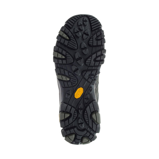 Black rugged hiking boot outsole with deep lugs and a yellow Vibram badge