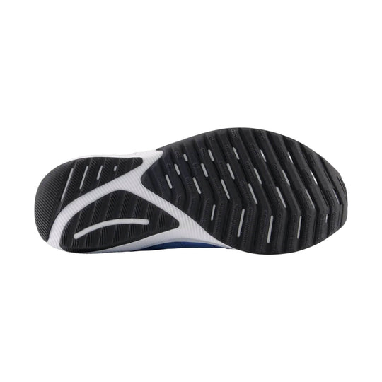 Black and white shoe outsole with grooved tread and flex grooves