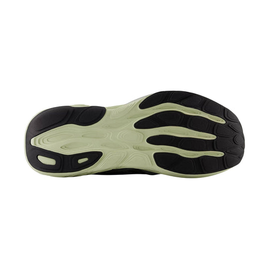 Black and pale green running shoe outsole with segmented tread and oval traction pods