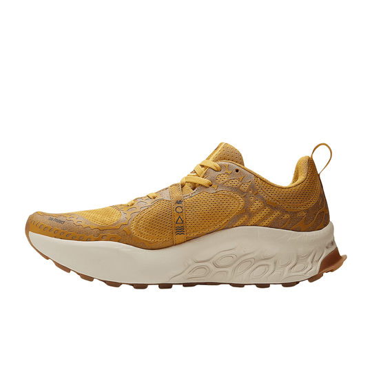 Golden trail running shoe with mesh upper, cutout overlays, and thick off-white midsole