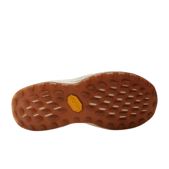 Trail shoe sole with brown rubber tread and yellow Vibram logo