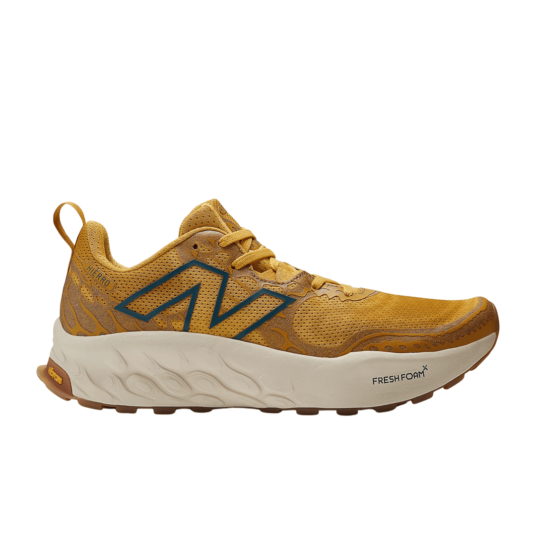 Golden yellow trail running shoe with a blue side logo, white midsole, and visible "FRESH FOAM X" text