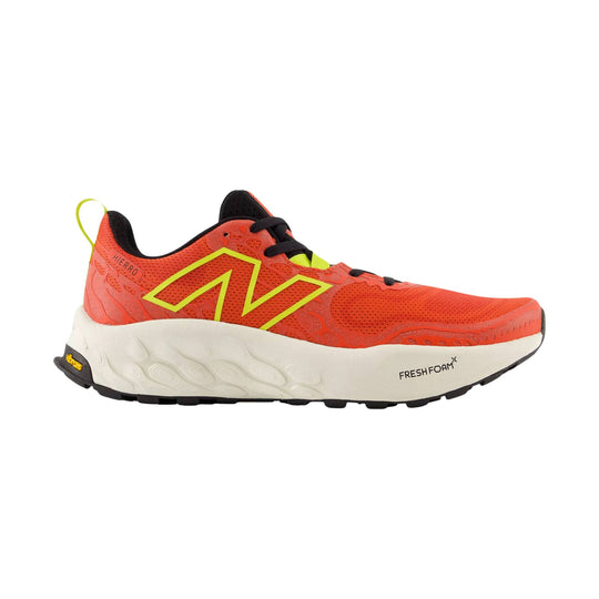 Orange trail running shoe with black laces, neon yellow logo, and white midsole