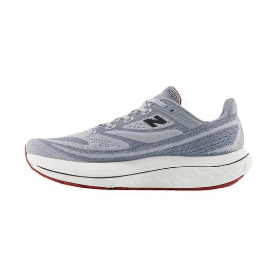 Gray New Balance running shoe in side view with thick white sole and red outsole accents