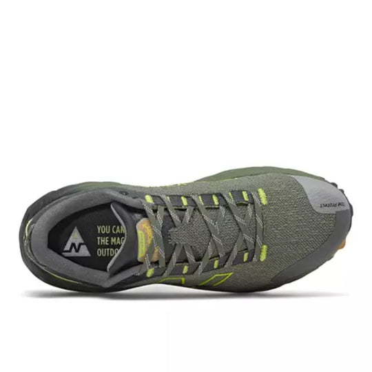 Gray trail running shoe with neon yellow accents, crisscross laces, and a black sole, shown from above