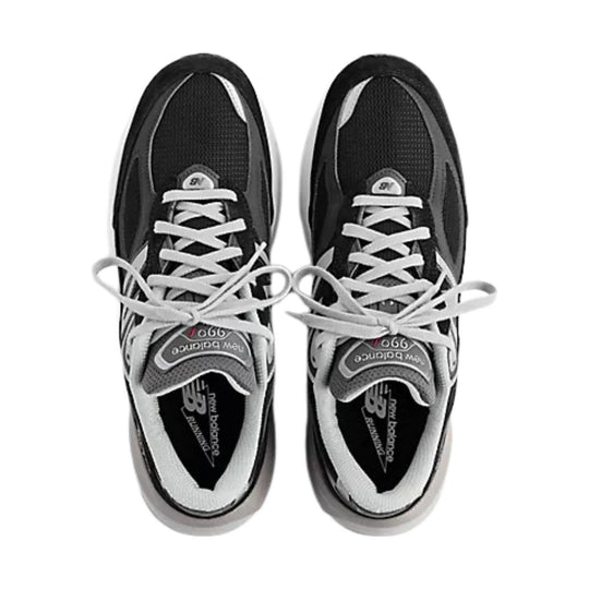 Black and gray athletic sneakers with white laces, shown from above on a white background.