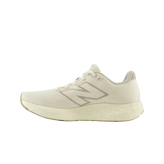 Cream knit running shoe with a thick foam sole and side logo