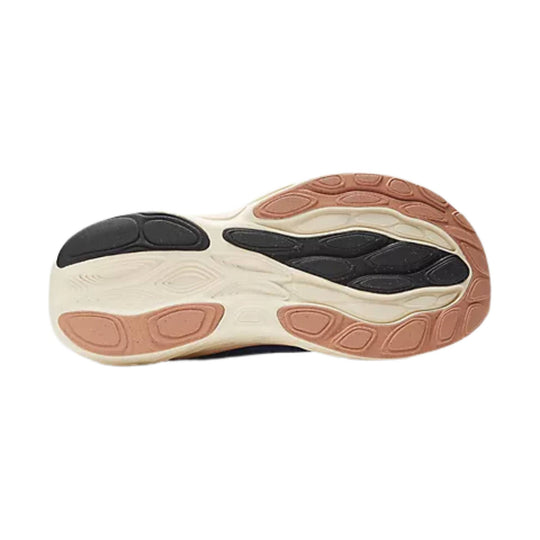 Shoe outsole with cream midsole, black tread pods, and tan rubber sections