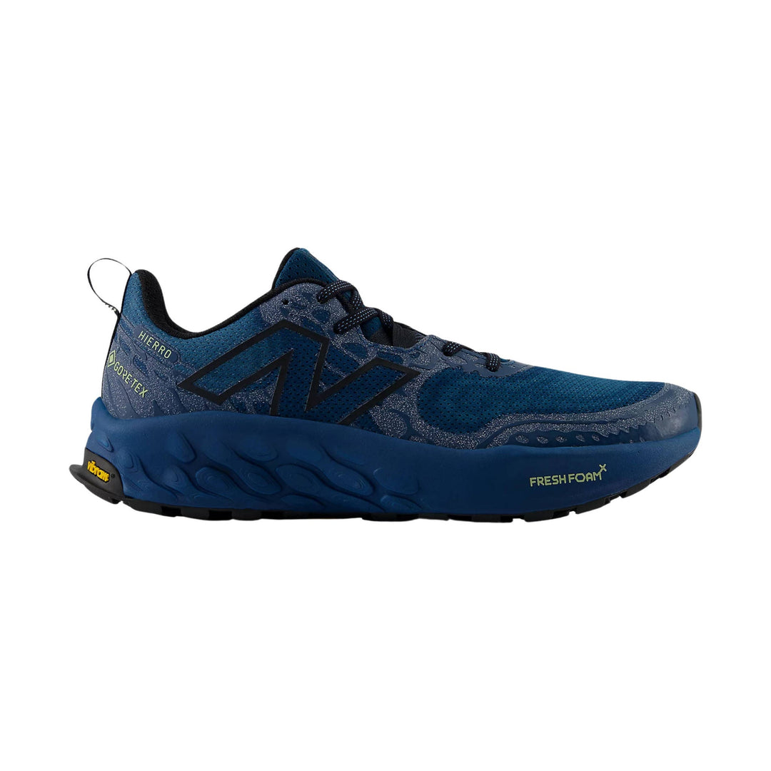 Blue trail running shoe with black logo, mesh upper, and lugged sole