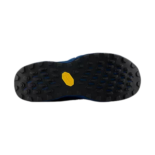 Black trail shoe outsole with deep lugs and blue accents