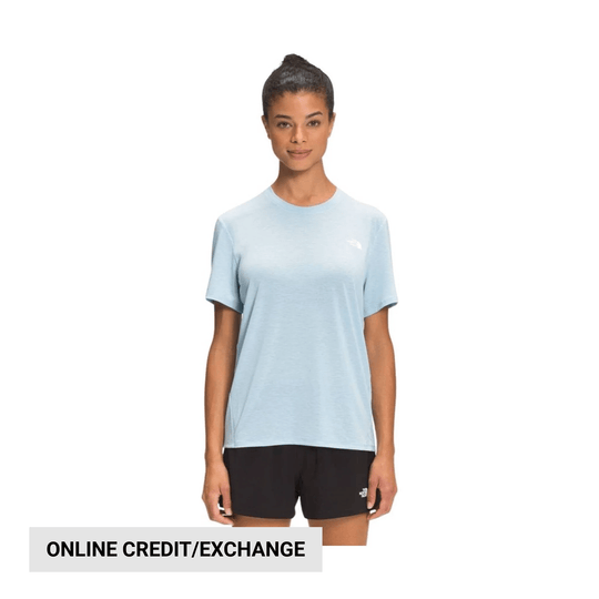 Light blue short-sleeve T-shirt with a small chest logo, shown with black shorts on a model