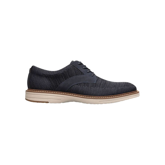 Navy knit oxford shoe with lace-up closure and light beige sole, side view