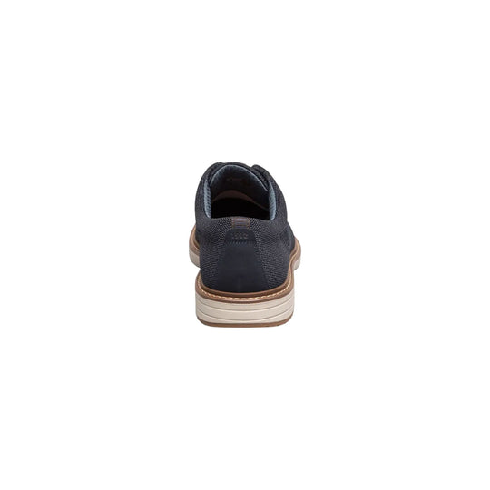 Navy knit oxford shoe shown from the back with a tan-and-white platform sole