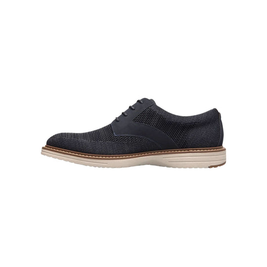 Navy knit oxford shoe with lace-up front and light beige sole