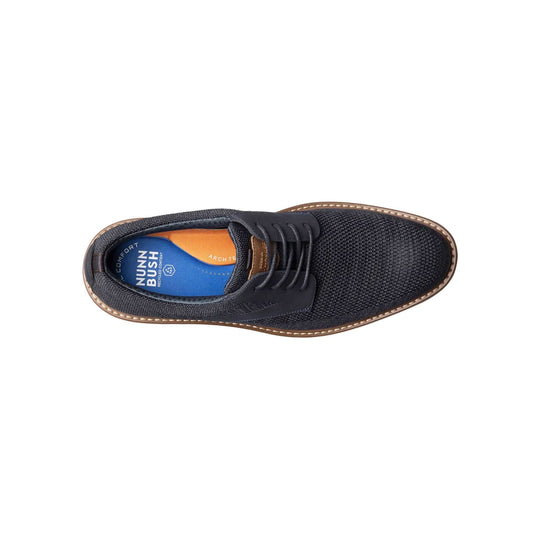 Top-down view of a navy knit oxford shoe with brown welt stitching and blue insole branding