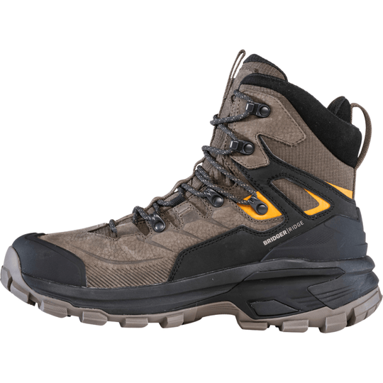 Brown and black mid hiking boot with orange side accents, speed lacing, and a lugged sole