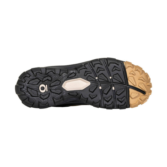 Black hiking shoe outsole with tan rubber toe and heel tread