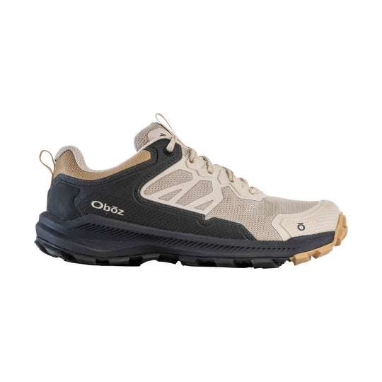 Beige and black low hiking shoe with mesh panels, tan laces, and a rugged treaded sole