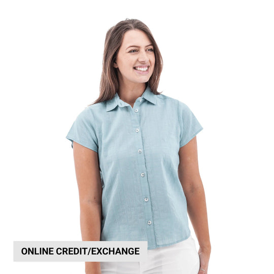 Light blue short-sleeve button-up camp shirt on a woman