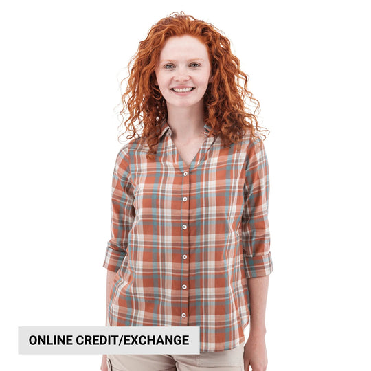 Plaid long-sleeve button-up shirt with rolled sleeves, shown on a model