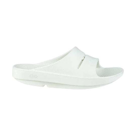 White slip-on slide sandal with a cushioned footbed and wide strap
